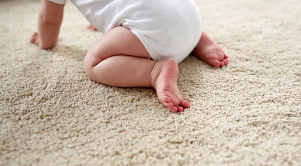 baby crawling on clean carpet